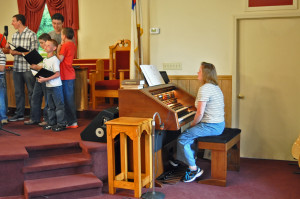 Sis. Jenny Young plays the organ for the youth choir.