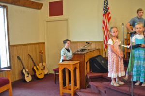 Sis. Caroline Proctor plays the piano for the youth choir.